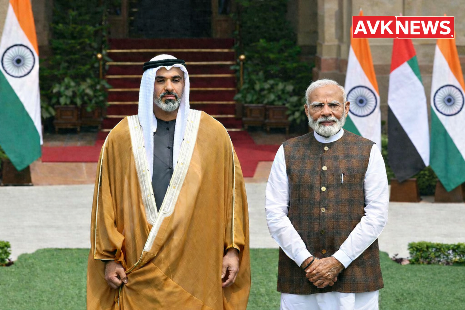 Two leaders standing at a formal ceremony with India and UAE flags and AVK News logo